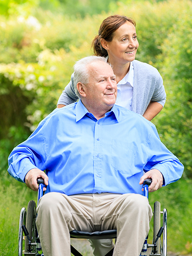 man in wheelchair with nurse